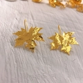 18K gold plated maple leaf dangle earrings with textured finish on a wooden background - Maple Leaf Style 2