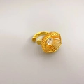 Detailed view of a gold-plated cage ring featuring a large brilliant-cut zircon stone - Gold