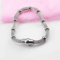 Silver mesh woven stainless steel bracelet with magnetic clasp on pink background - Steel