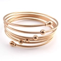Detailed macro view of multi-layer rose gold cable bracelet with metallic beads - Rose Gold
