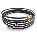 Macro detail of layered black twisted steel cable bracelet with gold and silver beads - Black (With Three-Color Beads)