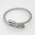Detailed macro view of silver twisted steel cable bracelet with polished ball ends - Silver
