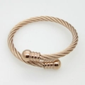 Macro view of rose gold twisted cable cuff bracelet with textured ball end caps - Rose Gold