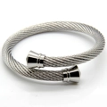Vue macro d'un bracelet câble torsadé argenté avec embouts coniques en métal poli - Couleur Acier