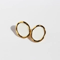 Vintage gold oval stud earrings with white enamel inlay on a clean white background - White