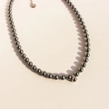 Elegant necklace with dark grey pearls and a round metal ball pendant in vintage style - Dark Gray