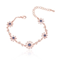 Elegant rose gold flower bracelet with blue round crystals and zircon stones on white background - Rose Gold Metal with Blue Rhinestone