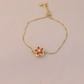 Detail of adjustable gold flower bracelet with red crystals and pull-string slider clasp - Orange