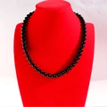 Polished black agate beaded necklace on a red display stand with shiny round beads - 8MM Black
