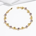 Close-up of gold heart-shaped bracelet with purple zircon and jewelry clasp - Purple Heart Stone (TS0374) / Purple Bracelet (TS0374)
