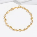 Detail of gold leaf-shaped link bracelet with sparkling zircon stones on white silk - Wavy Leaf Clear Style (TS0365)