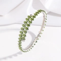 Detailed close-up of an open bangle with olive green marquise-cut crystals on silk - Silver Base Olive Green Zirconia (TT0258)