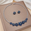 Elegant floral jewelry set with blue pear-cut zircons on a luxury display stand - Blue Yellow Gem Floral (PJ-113)