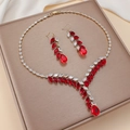 Elegant gold necklace and red zircon teardrop earrings set displayed on a luxury jewelry box - Red Pear Shape Gold (PJ-115)