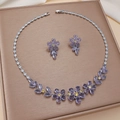 Fashion jewelry set with purple zircon flower necklace and earrings on a brown display - Purple Five-petal Floral (PJ-172)