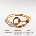 Gold plated brass knot bangle featuring a double-loop open design and polished finish - Gold Bangle