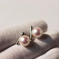 Minimalist silver bar earrings with glossy white round pearls in a modern geometric style - White Gold