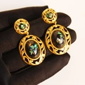 Pendientes vintage dorados con encaje ovalado e incrustaciones de nácar en la mano - Estilo de Gota Ovalada / Dorado