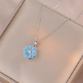 Macro shot of silver sunflower necklace with light blue petals and zircon center - X0797 - Dark Blue