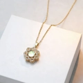 Titanium steel necklace with rotating snowflake pendant and opal stone on white box - Golden Rotating Flower Style (X3381-Necklace)