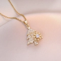 Close-up of golden Christmas tree necklace with a rotating snowflake and white zircons - Gold Christmas Tree Rotating Necklace (X1451)