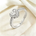 Macro shot of silver heart ring with sparkling crystals on white silk background - White (J0233-3)