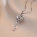 Elegant rotating zircon key pendant necklace in silver stainless steel on silk background - Rotating Flower Key Pendant (X0411-2) / Steel