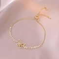 Golden butterfly slider bracelet with marquise-cut stones on purple silk background - Gold Hollow Butterfly Style (TS0085)