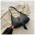 Chic black hobo underarm bag with gold metal clasp on a stylish cream blazer backdrop - Black