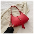 Detail of red crescent shoulder bag with gold metal clasp and vertical leather strap - Red