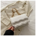 Macro shot of white lychee grain crossbody bag with wavy edges and gold FASHION logo - White