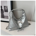 Detail of silver metallic hobo bag featuring lace-up bow and detachable metal chain - Silver