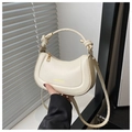Detail of cream crescent bag featuring knotted handle gold hardware and fashion logo - White