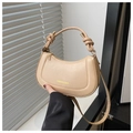 Detail of knot handle and golden metal ring on this beige crescent PU handbag - Khaki