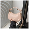Detail of knotted handle and gold zipper on a pink semi-circle faux leather handbag - Pink