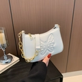 White faux leather underarm bag with butterfly embossing and gold chain strap - White