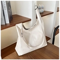 Detail of cream PU leather tote bag featuring vertical stitching and metal buckle - Off White