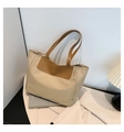 Minimalist beige and brown nylon tote bag with golden Fashion print in lifestyle setting - Khaki