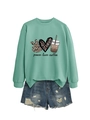 Detail view of mint green sweatshirt with peace love coffee print and ripped denim shorts - Light Green (Black Print)