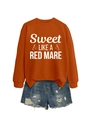Detail of terracotta crewneck sweatshirt with horse graphic and distressed denim shorts - Burnt Orange (White Font)