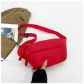 Close-up of bright red nylon waist bag with dual zippers and adjustable woven strap - Red