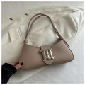 Detail of apricot baguette bag featuring a silver metal M-shaped decorative buckle - Khaki