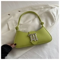 Detail of avocado green baguette bag with gothic silver buckle and knotted shoulder strap - Green