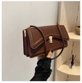 Detail of dark brown leather shoulder bag featuring gold hardware and pleated structure - Brown