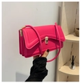 Detail view of pink flap bag showing three-layer accordion structure and gold buckle - Rose Pink