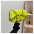 Detailed shot of neon green small crossbody bag with premium gold metallic lock closure - Green