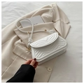 Detail view of white quilted underarm bag with heart stitching and gold hardware - White