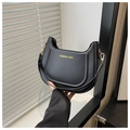 Detail of black leather half-moon shoulder bag with gold hardware and fashion lettering - Rose Red