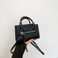 Minimalist black PU leather crossbody handbag with silver hardware and adjustable strap - Black