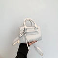 White mini city bag with silver hardware, long tassels, and adjustable shoulder strap - White